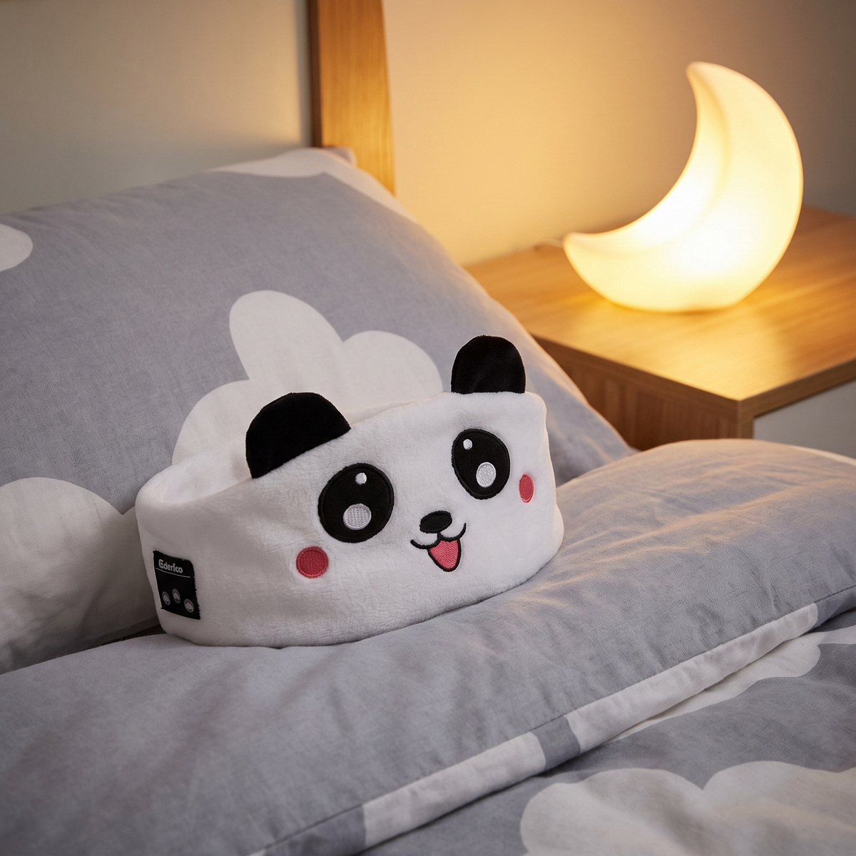 Panda sleep mask headphones on a child's pillow